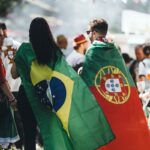 A group of people standing around each other holding flags