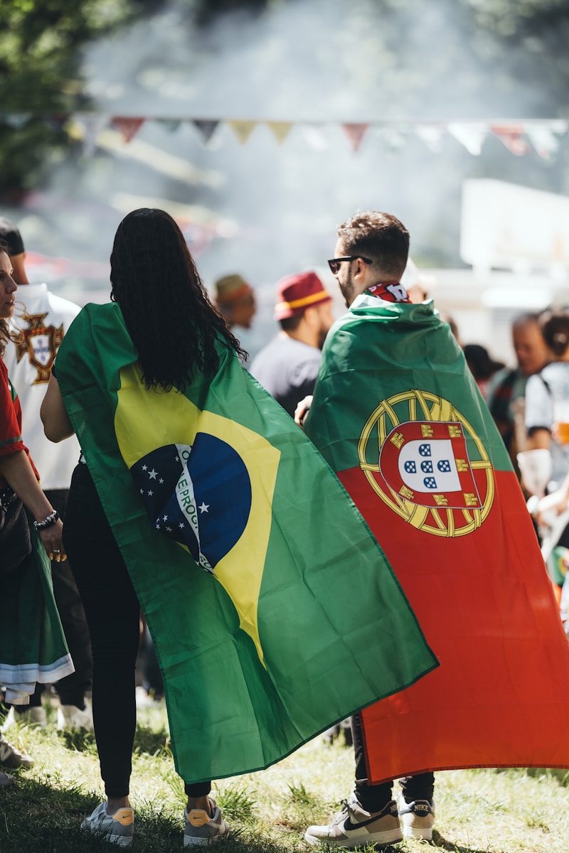 A group of people standing around each other holding flags